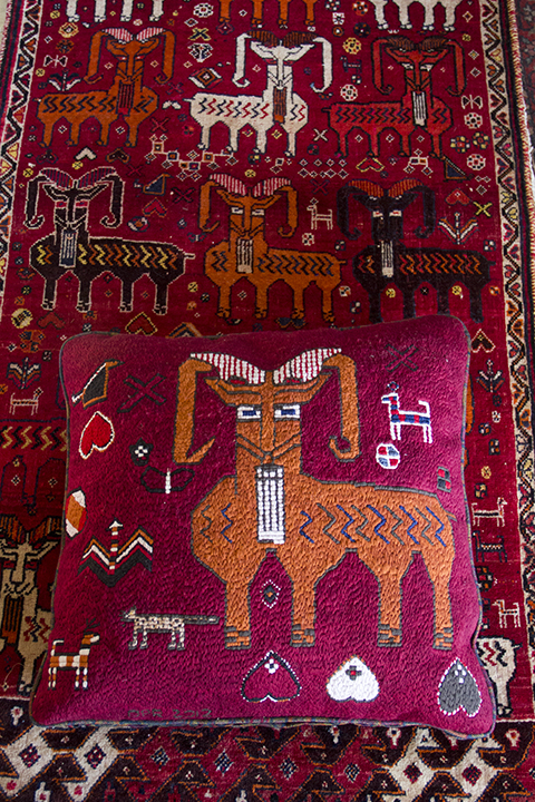 Goat Pillow Completed, resting on the Qasq’ai Persian carpet